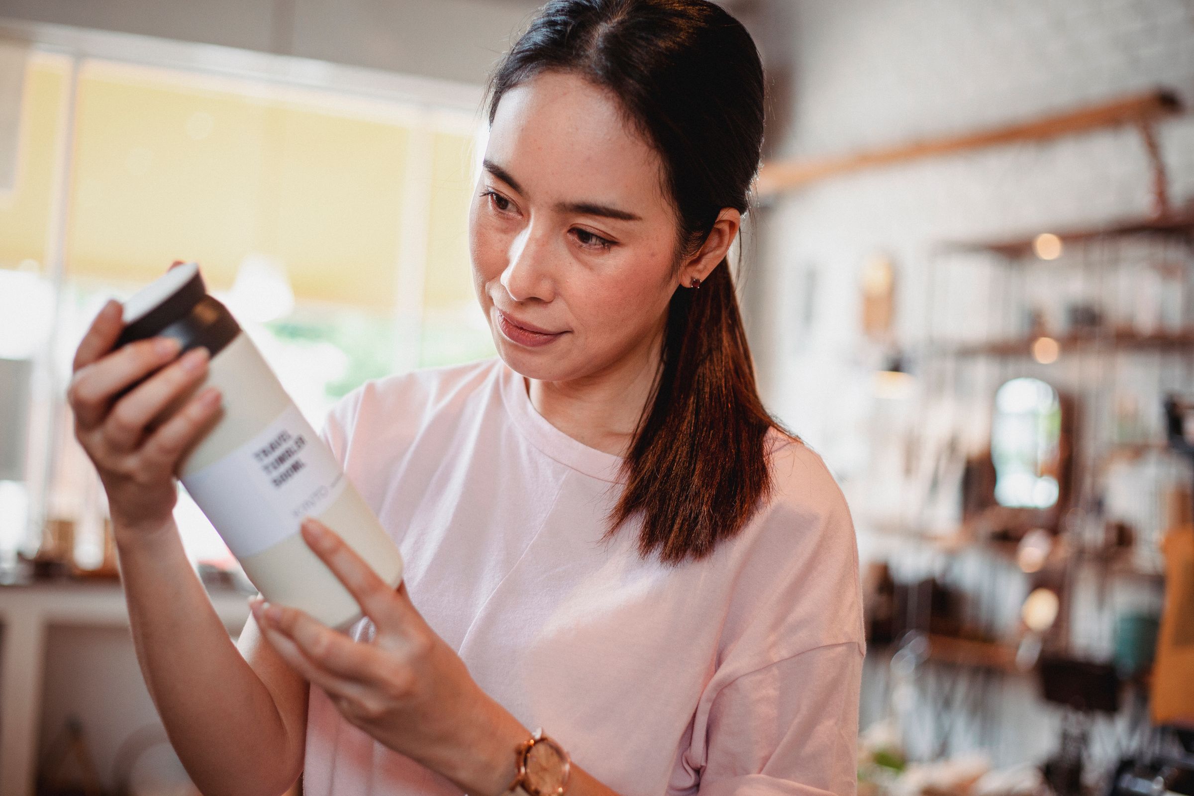 A woman reading the label on a pack